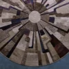Luxury designer circular rug with geometric radial pattern in beige, brown, and navy.