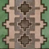 Luxury designer rug featuring interlocking geometric shapes in beige, green, and brown with handmade hide texture.