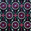 Close-up of Aubusson Hide 16290 luxury designer rug, featuring a geometric floral pattern in purple, pink, blue, and white on dark hide.