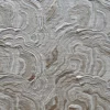 Close-up of luxury designer rug with wavy beige patterns, inspired by handmade hide rugs.