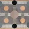 Atlas Hide 30060 luxury designer rug with geometric black, tan, and gray shapes and a wood border.