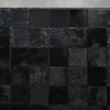 A grid of glossy black designer rug tiles, Promenade Hide 30151, for luxury custom rugs.