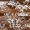 Close-up of a luxury designer rug with geometric mosaic in handmade brown and white hide.