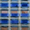 Close-up of a luxury designer rug with blue, brown, and cream textured plaid pattern.