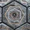 Close-up of a luxury designer rug with a geometric hexagon pattern in light and dark gray fur.