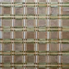 A close-up of a designer handmade hide rug with green, brown, and silver grid lines.