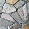 Irregular geometric handmade hide rug in gray, beige, tan with blue borders—luxury designer high end rug.