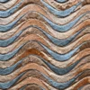 Close-up of wavy brown and blue patterns on a luxury designer handmade hide rug.