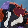 Luxury designer rug with abstract purple, orange, and maroon shapes on Custom Hide 15947.
