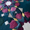 Kasbah Hide 15910 luxury designer rug with geometric pink, teal, and yellow pattern and fur-like handmade hide texture.