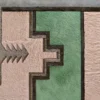 Luxury custom designer rug with geometric beige, green, and gray hide panels outlined in dark brown.