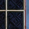 Luxury custom hide designer rug with geometric blue, black, and tan patterns on display.