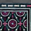 Luxury designer rug Aubusson Hide 16290 with maroon, pink, and green floral motifs on black.