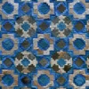 The Crossroads Hide 15073 high end designer rug with handmade patchwork in blue, gray, white, and beige geometric patterns.