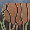 Close-up of luxury designer rug with vertical wool lines and abstract wood grain on a gray base.