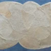 Luxury custom designer rug with abstract beige and cream ovals on blue surface.