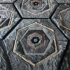 Close-up of luxury designer rug with hexagonal tiles and gray fur-like handmade texture.