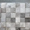 Luxury designer rug, 3 Lock Box Hide 15460, handmade from gray and white hide squares on concrete floor.