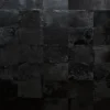 A wall of square black tiles with unique textures, perfect for showcasing luxury custom rugs or handmade hide designer rugs.