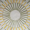 Luxury designer rug with abstract radial yellow and green lines on textured white.