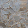 Close-up of Hide 29827 luxury designer rug, handmade hide with gold detail and textured abstract metallic patterns.