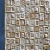 Luxury designer rug with geometric beige and brown squares, handmade hide texture on dark blue floor.