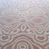 Luxury designer wool rug in pink and beige with abstract ovals and diamond motifs.