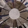 Luxury designer rug with multi-colored hide segments in a circular handmade pattern.