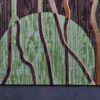 Luxury custom wool rug with brown and black vertical lines over a green semicircle on dark, designer high-end rug background.