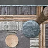 Close-up of a luxury high end handmade hide designer rug with geometric brown, gray, and beige pattern.