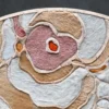 Bloom Hide 16038 luxury designer rug with abstract beige, pink, and orange hues on a dark background.