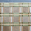 Luxury designer hide rug resembling a grid-patterned tabletop in premium browns and greens.