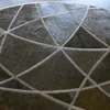 Silhouette Hide 27680 designer rug features a dark round surface with abstract lines, exemplifying luxury handmade hide rugs.
