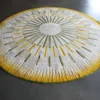 The Shadowplay Hide 26287 luxury designer rug features a white center, green and yellow lines, and a yellow edge on a dark gray floor.