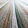 Luxury designer rug in Jet Stream Wool 15357, handmade with textured stripes in beige, green, brown, and gray.