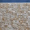The Surrender Hide 15561 luxury designer rug features a mosaic of textured, handmade hide tiles on a dark blue background.