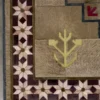 The Winterlude Hide 26020 is a luxury designer rug with geometric maroon and beige star motifs and fur-like handmade hide texture.