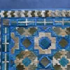 Close-up of Crossroads Hide 15073 designer rug with geometric squares on a blue luxury handmade hide rug background.