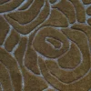 Close-up of a luxury designer rug with abstract raised brown patterns on a textured, high-end gray wool surface.