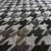 Textured close-up of Blackdog Wool 15851, a luxury handmade wool designer rug in houndstooth.