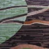 Luxury custom wool rug with abstract geometric green, brown, and black designer patterns.