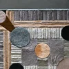 The Atlas Hide 30060 luxury designer rug features a geometric pattern in mixed neutral tones, crafted from high quality handmade hide materials.