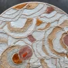 The Bloom Hide 16038 luxury designer rug features abstract layered patterns on a dark background in pink, orange, tan, and white.