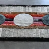 Luxury designer rug, The Atlas Hide 15902, features three bold circles on a geometric backdrop of handmade wool and hide strips.