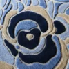 Close-up of luxury designer rug Bloom Silk Wool 30123, featuring a textured blue, beige, and navy abstract handmade pattern.