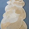 Luxury designer Custom Hide 12580 rug with organic beige shapes on a sleek grey floor.