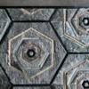 Luxury designer Cecelia Hide rug with geometric hexagons on concrete floor, handmade from premium materials.