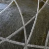 Close-up of Silhouette Hide 27680 luxury designer rug with textured, curved geometric lines on high-end handmade hide material.
