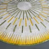 Shadowplay Hide 26287 is a round designer rug with yellow and green stitched lines on white, reflecting luxury custom rug artistry.