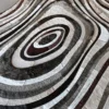 Luxury designer hide rug with irregular ovals in white, gray, brown, and black fur patches.